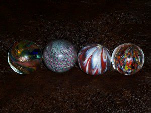 4 SIGNED COLLECTIABLE MARBLES.